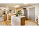 Bright kitchen with an island, wooden cabinets, stainless steel appliances and connection to the living area at 14291 Holly Berry Cir, Fishers, IN 46038