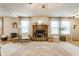 Living room with a fireplace, bright windows, and stylish décor at 14291 Holly Berry Cir, Fishers, IN 46038