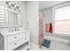Bright bathroom featuring a vanity with drawers and a decorative shower curtain at 1446 N Illinois St, Indianapolis, IN 46202