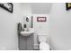 This half bathroom includes a sink, mirror, toilet, and art at 1446 N Illinois St, Indianapolis, IN 46202