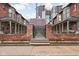 Charming brick facade with wrought iron fence and well-maintained flower beds at 1446 N Illinois St, Indianapolis, IN 46202
