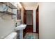 This lovely bathroom features tile floors, white fixtures, and wooden door at 16226 Montrose Ln, Westfield, IN 46074