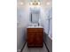 A small bathroom vanity with a wood cabinet and mirror, flanked by two hanging towels at 16226 Montrose Ln, Westfield, IN 46074