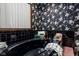 A stylish bathroom with a black tub, floral wallpaper, and a window for natural light at 16226 Montrose Ln, Westfield, IN 46074