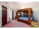 Spacious bedroom featuring a four-poster bed, matching dresser, overhead lighting, and closet at 16226 Montrose Ln, Westfield, IN 46074