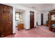 View of primary bedroom with pink carpet, wood trim and doors, built in storage niche and wood furniture at 16226 Montrose Ln, Westfield, IN 46074