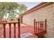 Side view of spacious wooden deck features red railing and brick wall at 16226 Montrose Ln, Westfield, IN 46074