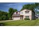 Beautiful two-story house showcasing a blend of brick and siding, an attached garage, and lush greenery at 16226 Montrose Ln, Westfield, IN 46074