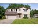 Charming two-story home featuring a brick and siding exterior with a well-maintained lawn and a two-car garage at 16226 Montrose Ln, Westfield, IN 46074
