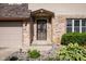 Close-up of front entrance, showing brickwork, decorative door, and landscaped garden bed at 16226 Montrose Ln, Westfield, IN 46074