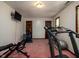 Home gym features a treadmill, stationary bike, multiple doors, and neutral walls at 16226 Montrose Ln, Westfield, IN 46074
