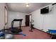 Home gym features a treadmill, stationary bike, TV, and neutral walls at 16226 Montrose Ln, Westfield, IN 46074