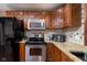 Stainless steel oven and microwave sit above granite counter-tops in this updated kitchen at 16226 Montrose Ln, Westfield, IN 46074