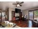 Comfortable living room featuring hardwood floors, a ceiling fan, and a TV at 16226 Montrose Ln, Westfield, IN 46074