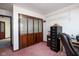 Home office showcasing folding glass doors, neutral colors, desk, and filing cabinet at 16226 Montrose Ln, Westfield, IN 46074