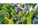 An aerial view showcases a home with a well-manicured lawn, mature trees and a winding walkway at 16890 Catkins Ct, Westfield, IN 46074