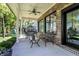 Covered back patio features a ceiling fan and outdoor seating for relaxing and enjoying the serene surroundings at 16890 Catkins Ct, Westfield, IN 46074