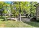 Beautiful backyard featuring mature trees, lush lawn, decorative rock garden, and professional landscaping at 16890 Catkins Ct, Westfield, IN 46074