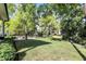 Private backyard with mature shade trees, a stone fire pit area, and lush landscaping for peaceful enjoyment at 16890 Catkins Ct, Westfield, IN 46074