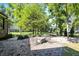 Backyard patio with a paver fire pit and seating surrounded by lush greenery and privacy landscaping at 16890 Catkins Ct, Westfield, IN 46074