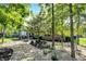 Scenic backyard features stone landscaping, mature shade trees, and a cozy fire pit area for outdoor enjoyment at 16890 Catkins Ct, Westfield, IN 46074