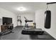 Home gym with various exercise equipment, including a treadmill, rowing machine, and punching bag on a rubber floor at 16890 Catkins Ct, Westfield, IN 46074