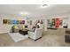 Comfortable basement lounge area features a large sectional sofa, unique wall art, and a seamless transition to a game area at 16890 Catkins Ct, Westfield, IN 46074