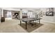 Spacious finished basement featuring a ping pong table, wood accent wall, and ample room for relaxation and entertainment at 16890 Catkins Ct, Westfield, IN 46074