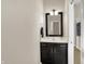 Well-lit bathroom featuring a dark vanity, framed mirror, and a clean, modern design at 16890 Catkins Ct, Westfield, IN 46074