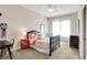 Charming bedroom features a black spindle bed frame, complemented by colorful accents and natural light from the window at 16890 Catkins Ct, Westfield, IN 46074