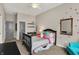 Bright bedroom with red polka dots on the wall features a black spindle bed frame, desk, and turquoise accent chair at 16890 Catkins Ct, Westfield, IN 46074