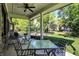 Covered patio with outdoor seating provides a beautiful view of the backyard's lush greenery and neighboring homes at 16890 Catkins Ct, Westfield, IN 46074