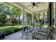 Inviting covered patio featuring neutral décor, ceiling fan, and a view of the manicured backyard and playground at 16890 Catkins Ct, Westfield, IN 46074