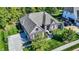 A well-maintained brick home with a three car driveway, manicured lawn and lush landscaping at 16890 Catkins Ct, Westfield, IN 46074