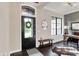 Inviting foyer with dark wood floors, stylish decor, and ample natural light from the front door and sidelight window at 16890 Catkins Ct, Westfield, IN 46074