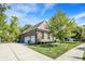 Spacious three-car garage with brick exterior, complemented by a well-manicured lawn and lush landscaping at 16890 Catkins Ct, Westfield, IN 46074