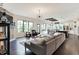 Spacious open-concept living room with a modern fireplace, large windows, and seamless flow to the kitchen and dining area at 16890 Catkins Ct, Westfield, IN 46074