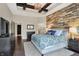 Spacious main bedroom featuring an elegant accent wall, wood floors, and tray ceilings at 16890 Catkins Ct, Westfield, IN 46074