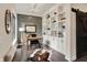 Bright home office featuring custom built-in shelves, hardwood floors, and stylish decor with ample natural light at 16890 Catkins Ct, Westfield, IN 46074