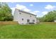 Large backyard features a well-kept lawn and a patio seating area, framed by a wooden fence at 18711 Crestline Ct, Noblesville, IN 46060