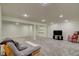 Finished basement with neutral walls, recessed lighting, carpet and furnished with a television and futon at 18711 Crestline Ct, Noblesville, IN 46060