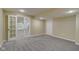 Finished basement with neutral paint, recessed lighting, carpet and connecting room beyond a glass door at 18711 Crestline Ct, Noblesville, IN 46060