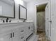 Bathroom with double sinks, updated hardware, and a view to the shower area at 18711 Crestline Ct, Noblesville, IN 46060