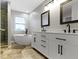 Modern bathroom with a soaking tub, double vanity, and walk-in shower at 18711 Crestline Ct, Noblesville, IN 46060