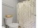 Close-up of the toilet and shower featuring neutral colors and design at 18711 Crestline Ct, Noblesville, IN 46060
