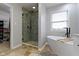 Modern bathroom with soaking tub, walk-in shower, and natural light at 18711 Crestline Ct, Noblesville, IN 46060
