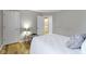 Bright bedroom featuring a bed with a bedside table and a view to the bathroom at 18711 Crestline Ct, Noblesville, IN 46060