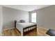 Cozy bedroom showcases a traditional bed frame and a bright window view at 18711 Crestline Ct, Noblesville, IN 46060