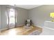 Bright bedroom features hardwood floors, a window view, and a cozy reading nook at 18711 Crestline Ct, Noblesville, IN 46060