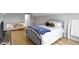 Brightly lit bedroom features an iron bed, sofa, and light colored floors at 18711 Crestline Ct, Noblesville, IN 46060
